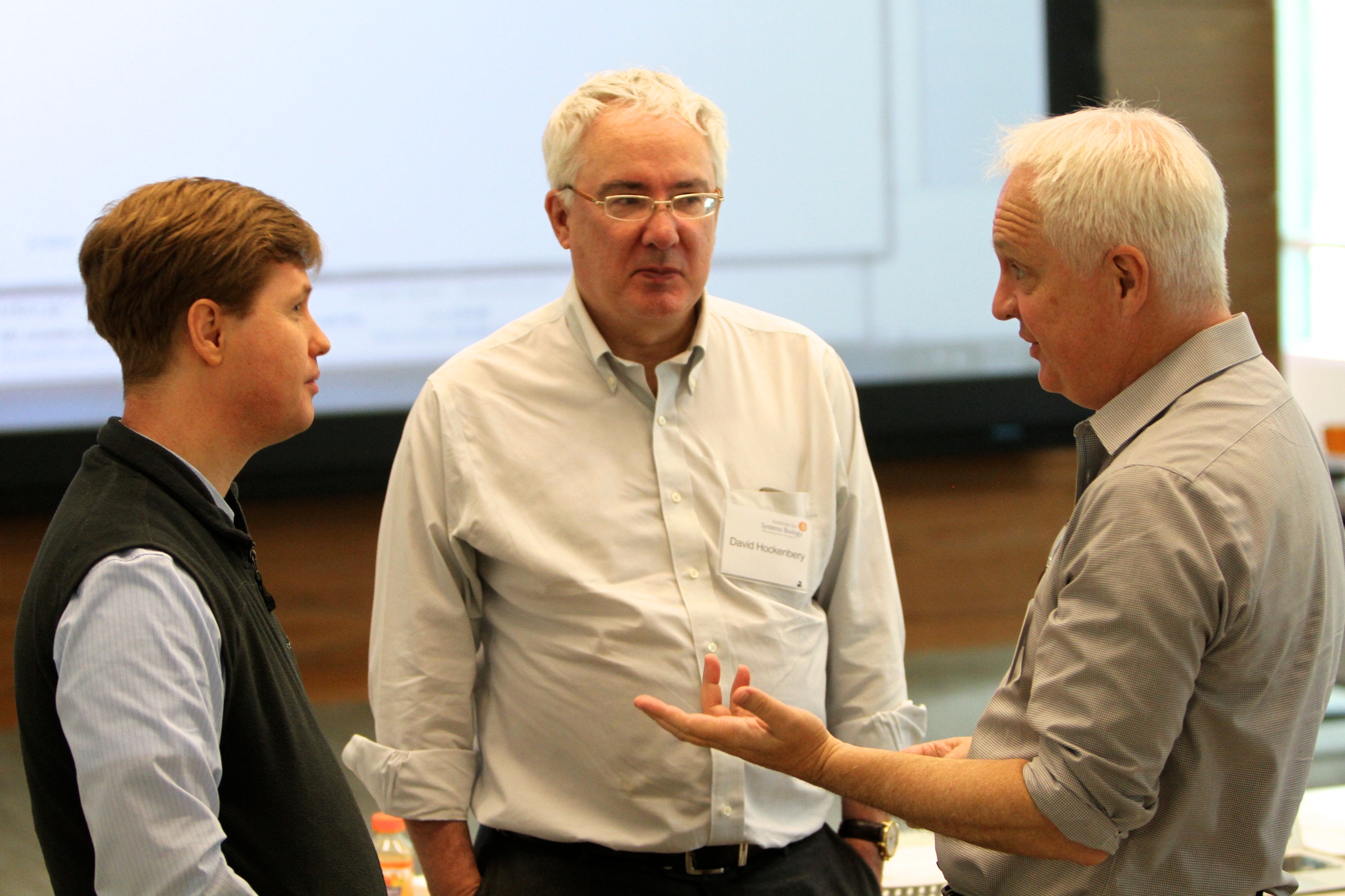 ISB's Dr. Nathan Price, left, chats with FHCRC's Dr. David Hockenbery and Dr. Eric Holland during a meeting held at Institute for Systems Biology to discuss potential collaborations on cancer research.